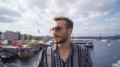 Young-Man-is-looking-at-the-sky-against-the-sea-in-Istanbul.